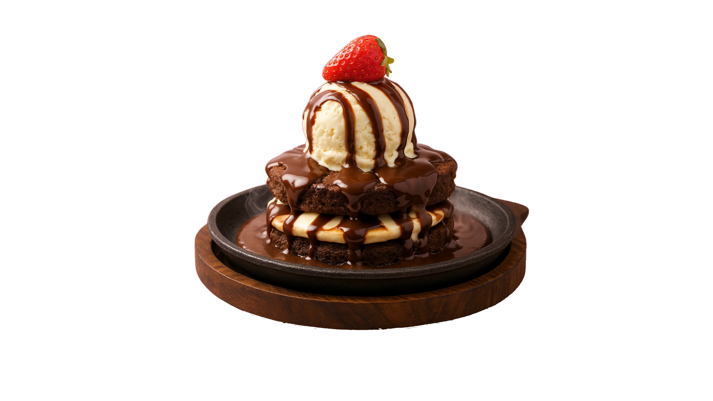 A brownie sizzler on a cast-iron plate, topped with a scoop of vanilla and a strawberry, chocolate sauce steaming underneath